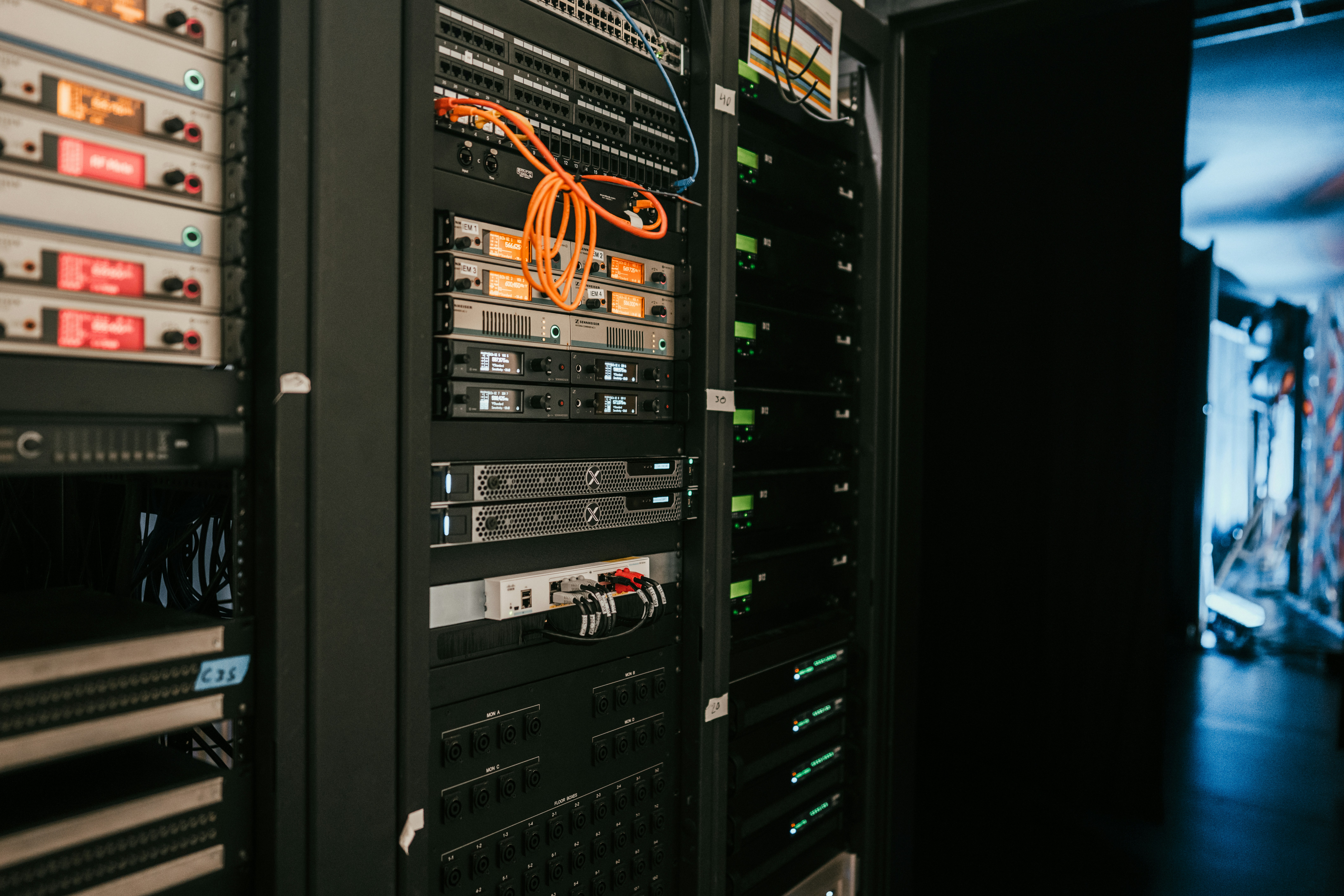 Racks of servers in a dimly lit server room.