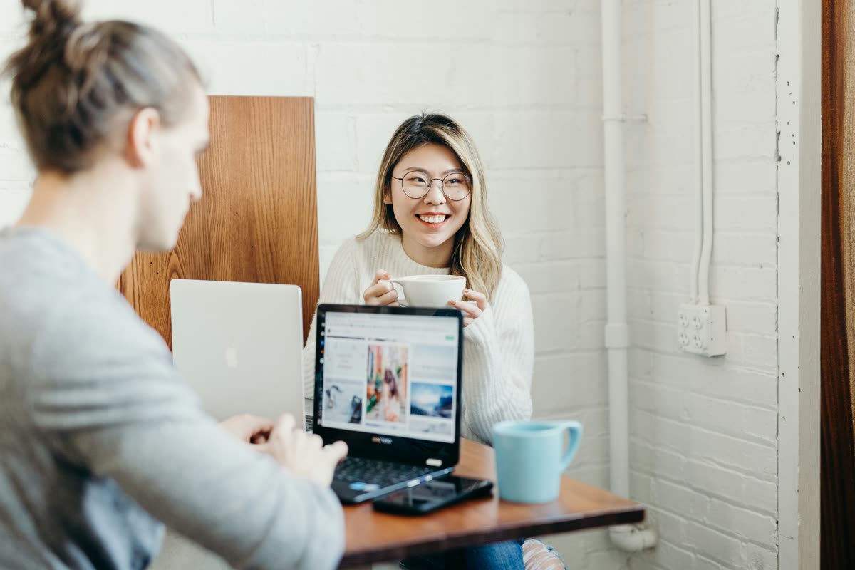 Two colleagues working together at a laptop